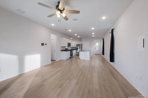 a view of kitchen and hall with wooden floor