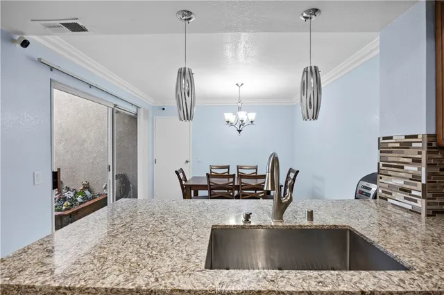 a view with a kitchen counter space a sink and appliances