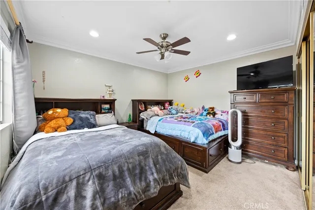 a bedroom with two beds and a flat screen tv