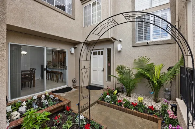 a front view of a house with a potted plant ana a potted plant