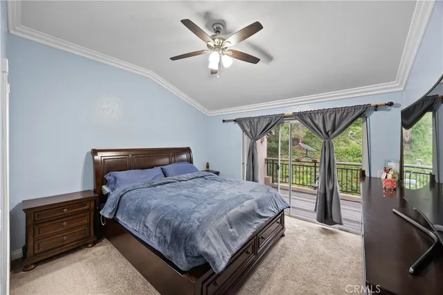 a bedroom with a bed and a large window with the outer view