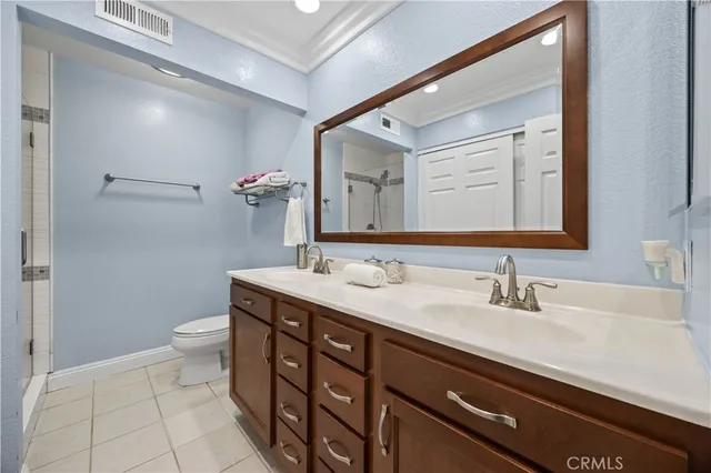 a bathroom with a double vanity sink and a mirror