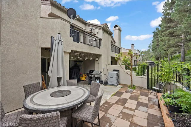 a front view of a house with a table and chairs