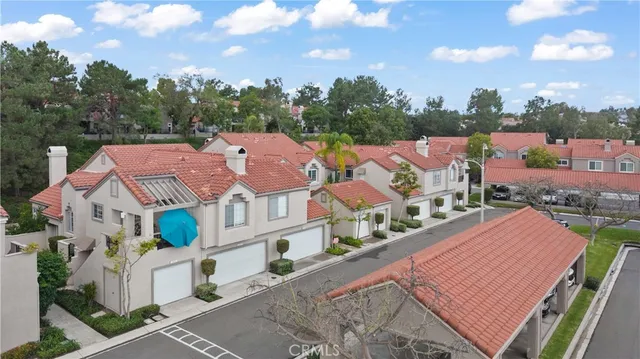an aerial view of a house with a yard