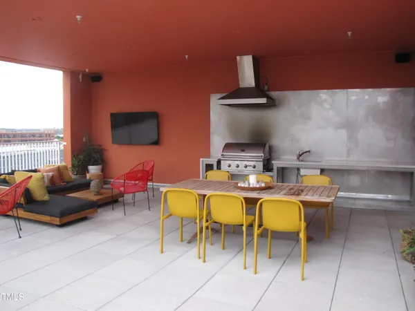 a view of a balcony dining table and chairs
