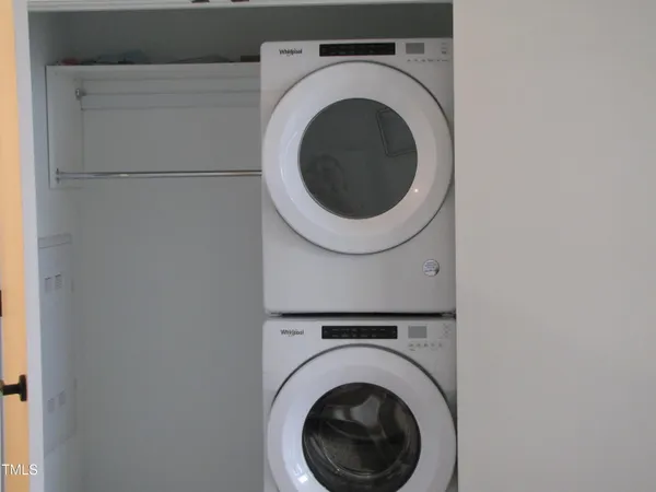 a living room with furniture a flat screen tv and a floor to ceiling window