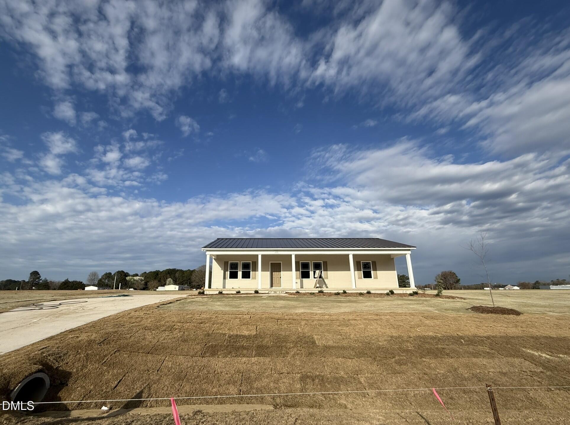 a front view of house with yard and car