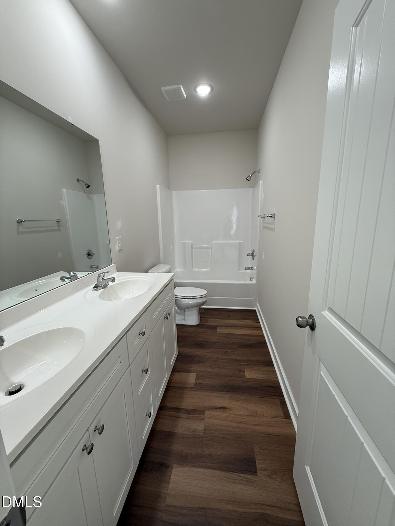 129 Jacobs Ridge Drive Four Oaks, NC 27524 - Photo 12 of 18 a spacious bathroom with double vanity and mirrors