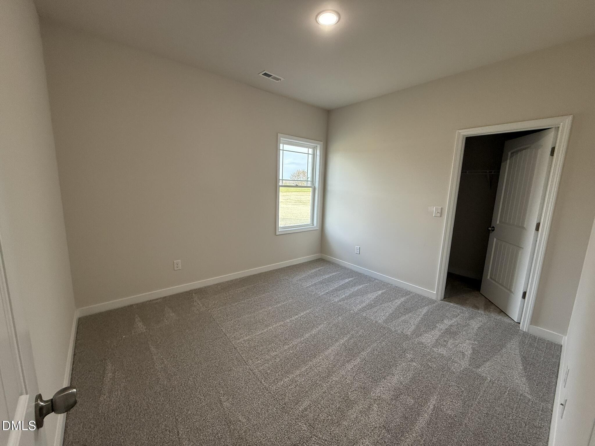 129 Jacobs Ridge Drive Four Oaks, NC 27524 - Photo 14 of 18 an empty room with windows and closet