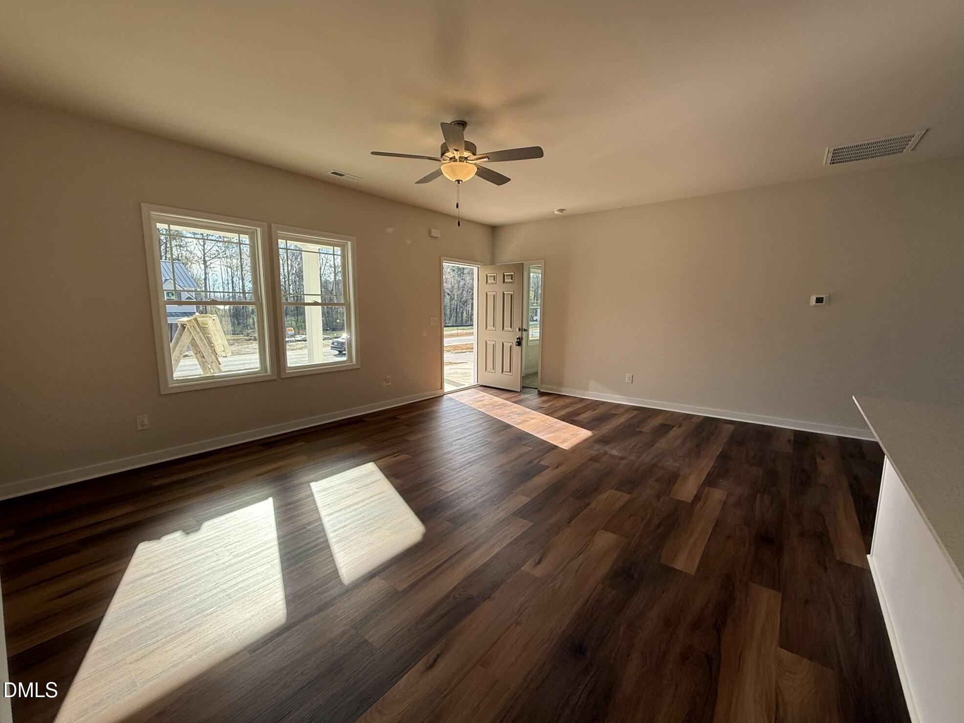 129 Jacobs Ridge Drive Four Oaks, NC 27524 - Photo 5 of 18 a view of an empty room with wooden floor and a window