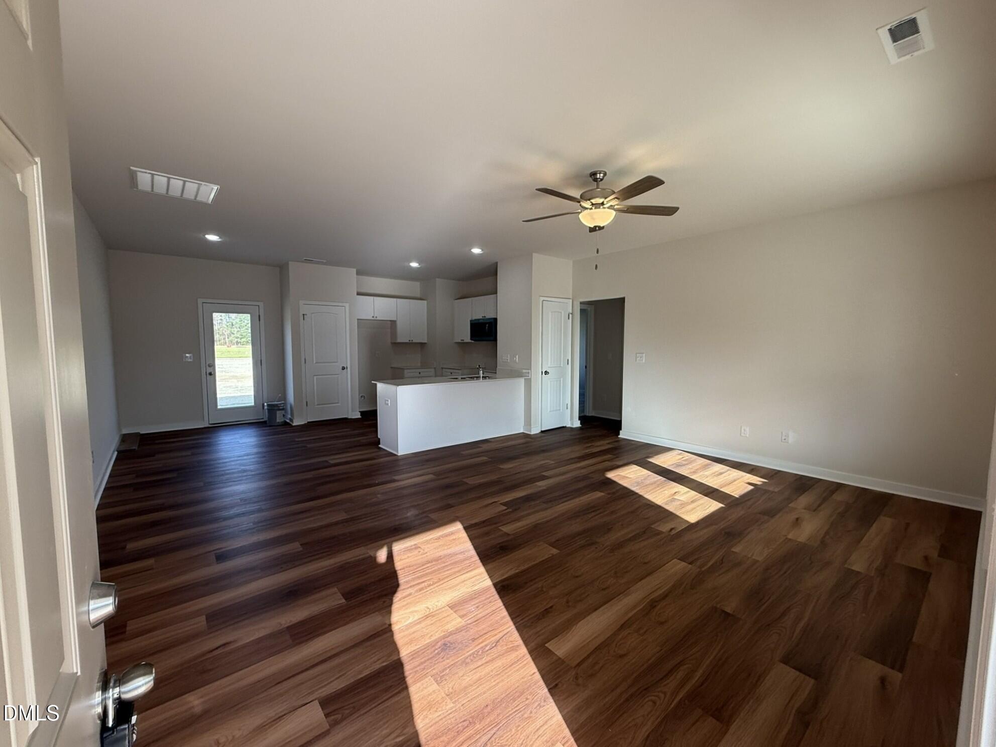129 Jacobs Ridge Drive Four Oaks, NC 27524 - Photo 7 of 18 a view of kitchen and empty room with wooden floor