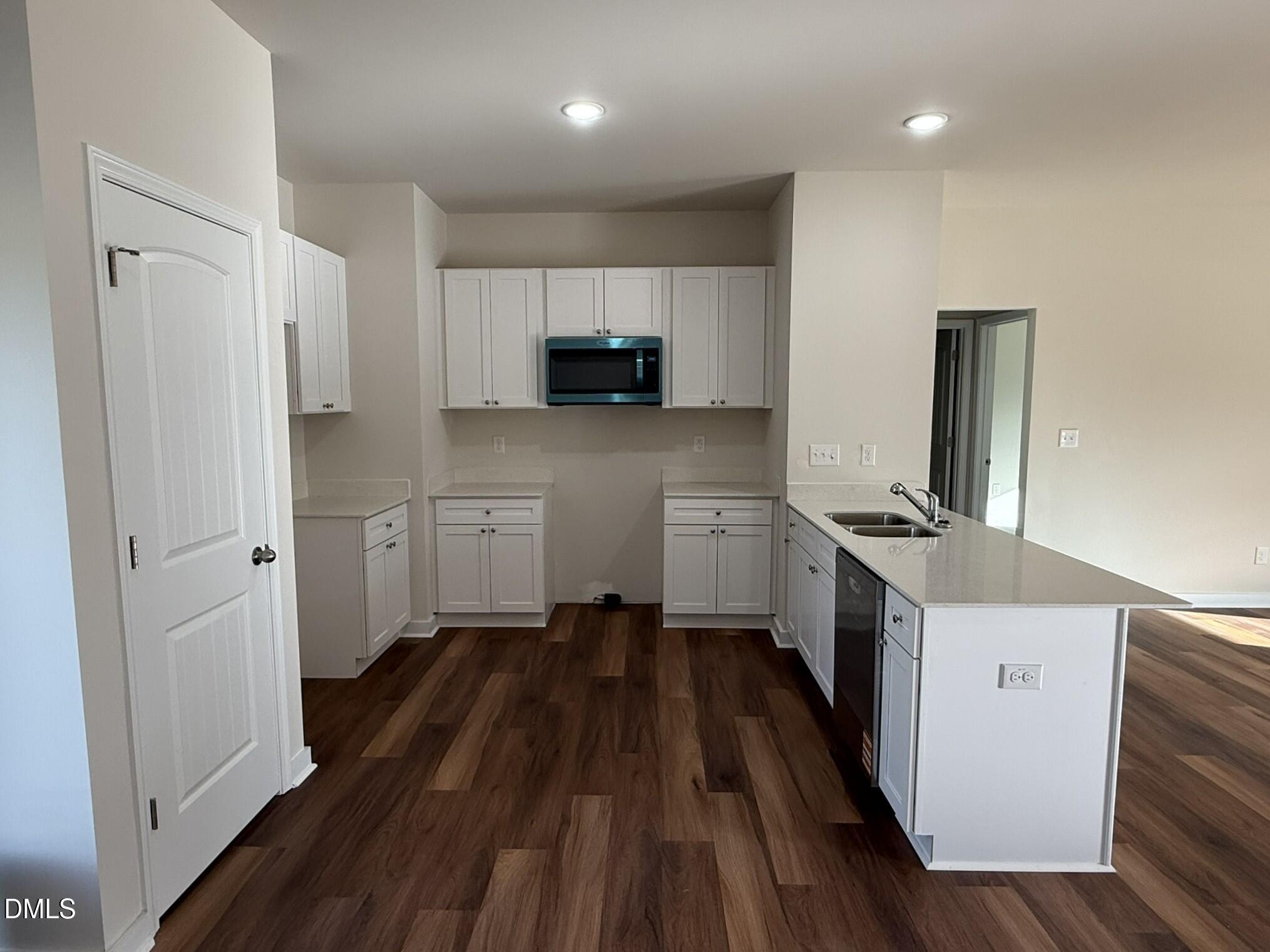 129 Jacobs Ridge Drive Four Oaks, NC 27524 - Photo 9 of 18 a kitchen with cabinets and wooden floor