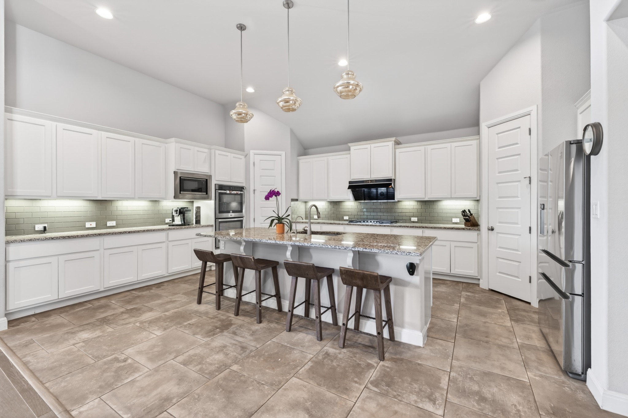 4105 Haight Street Round Rock, TX 78681 - Photo 18 of 40 a kitchen with kitchen island granite countertop a sink counter top space appliances and cabinets