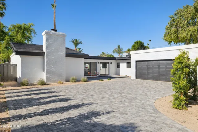 a front view of a house with a yard and a garage