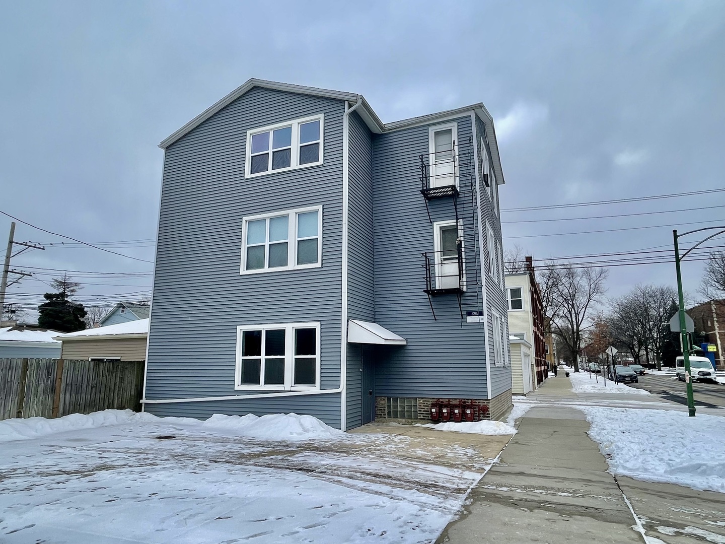 4155 West Roscoe Street Chicago, IL 60641 - Photo 7 of 11 a front view of a house with a yard