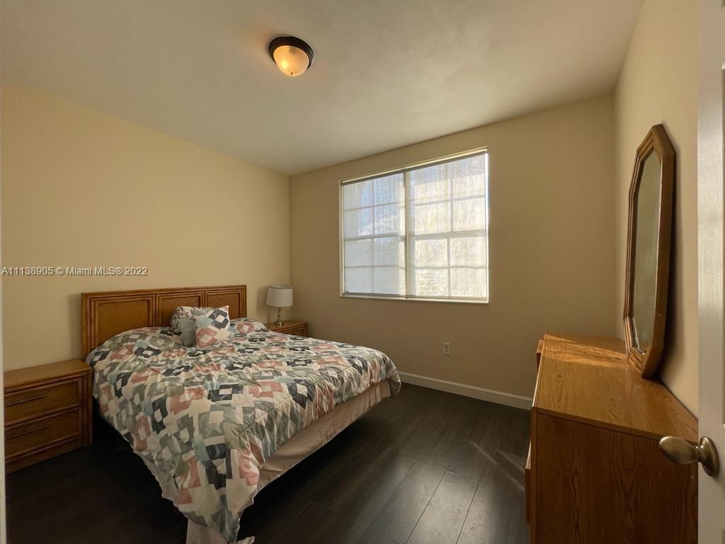 9323 Southwest 227th Street, Unit 75 Cutler Bay, FL 33190 - Photo 12 of 44 a bedroom with a bed and a window