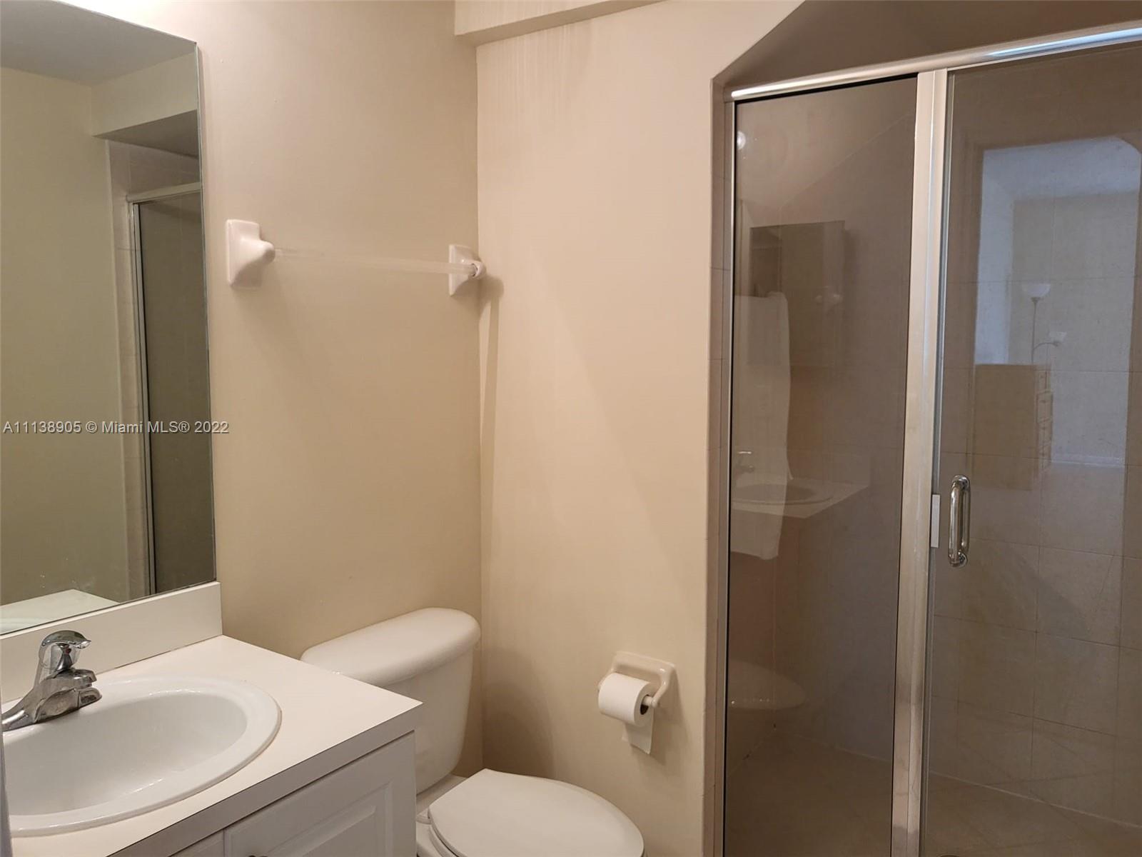 9323 Southwest 227th Street, Unit 75 Cutler Bay, FL 33190 - Photo 13 of 44 a bathroom with a sink toilet and shower