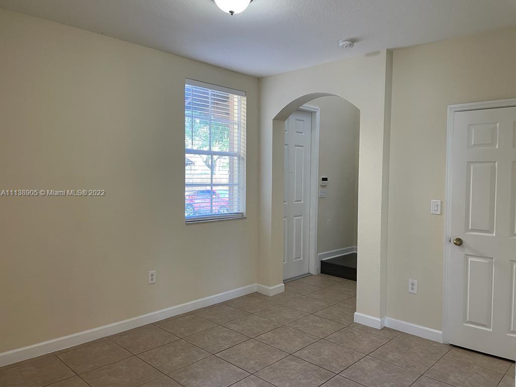 9323 Southwest 227th Street, Unit 75 Cutler Bay, FL 33190 - Photo 19 of 44 an empty room with windows