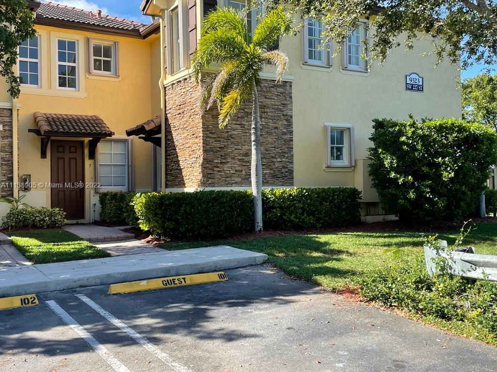 9323 Southwest 227th Street, Unit 75 Cutler Bay, FL 33190 - Photo 2 of 44 a view of a house with backyard and sitting area