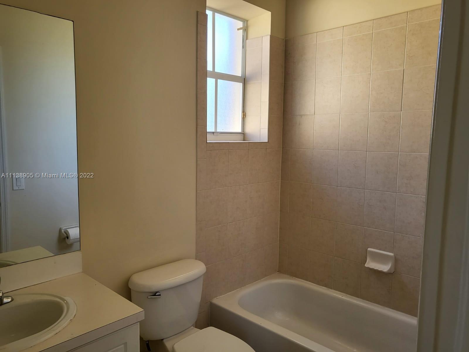 9323 Southwest 227th Street, Unit 75 Cutler Bay, FL 33190 - Photo 25 of 44 a bathroom with a toilet sink and bathtub