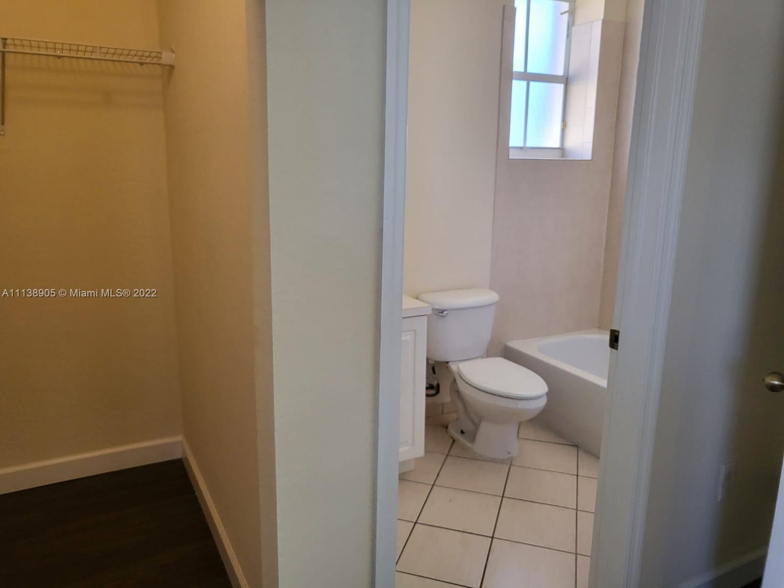 9323 Southwest 227th Street, Unit 75 Cutler Bay, FL 33190 - Photo 26 of 44 a bathroom with a toilet and a shower