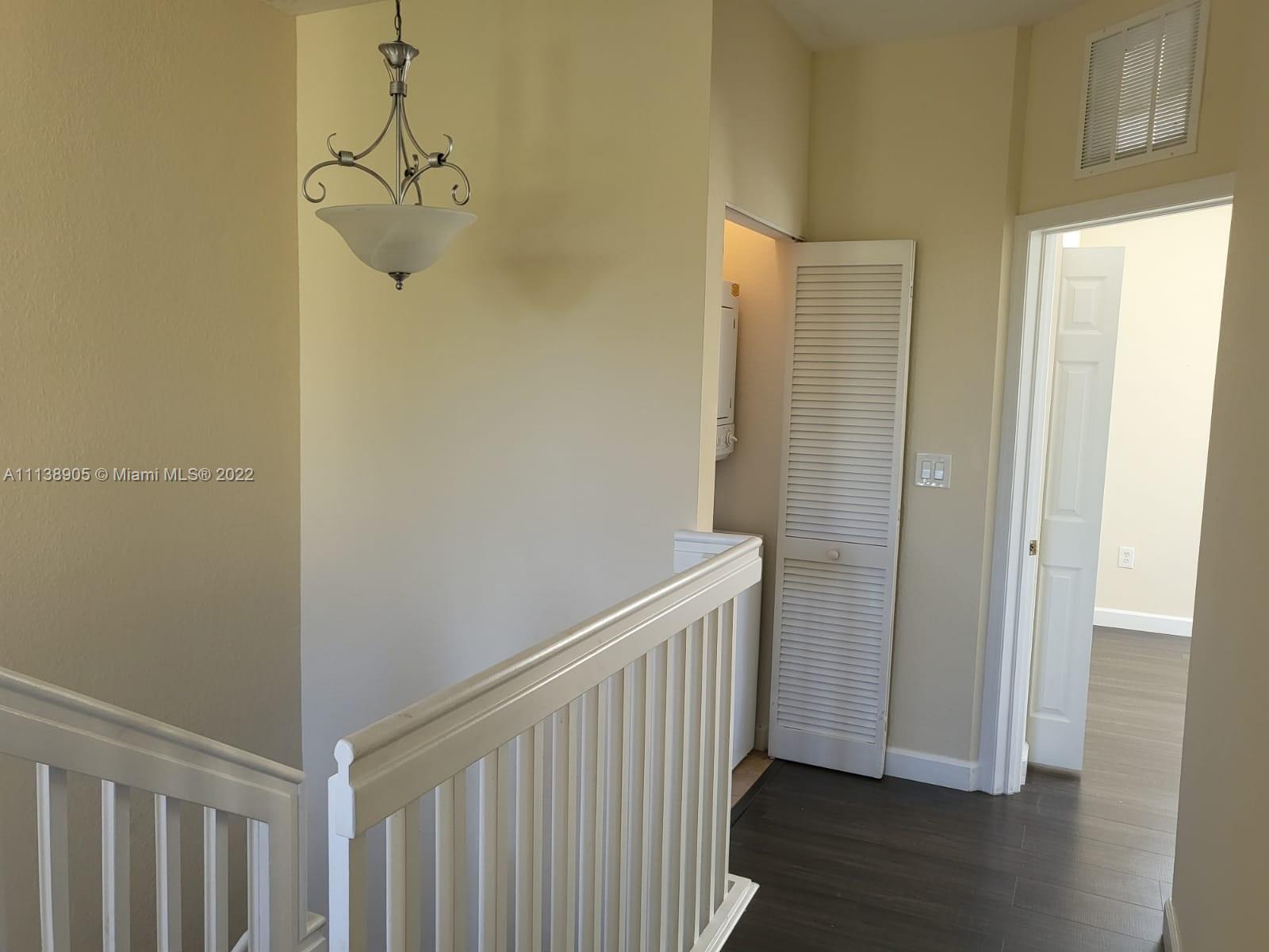 9323 Southwest 227th Street, Unit 75 Cutler Bay, FL 33190 - Photo 27 of 44 a view of a hallway with a small space