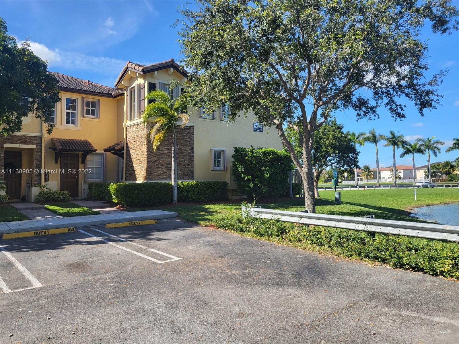 9323 Southwest 227th Street, Unit 75 Cutler Bay, FL 33190 - Photo 3 of 44 a view of a house with a yard and large tree