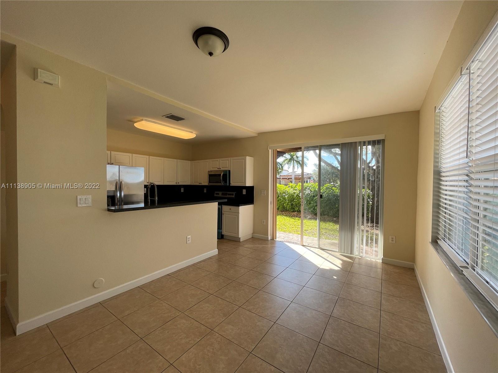 9323 Southwest 227th Street, Unit 75 Cutler Bay, FL 33190 - Photo 34 of 44 a view of an empty room and window