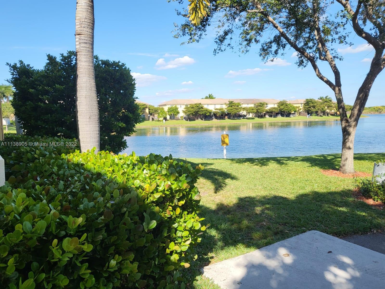 9323 Southwest 227th Street, Unit 75 Cutler Bay, FL 33190 - Photo 40 of 44 a view of a lake with a yard