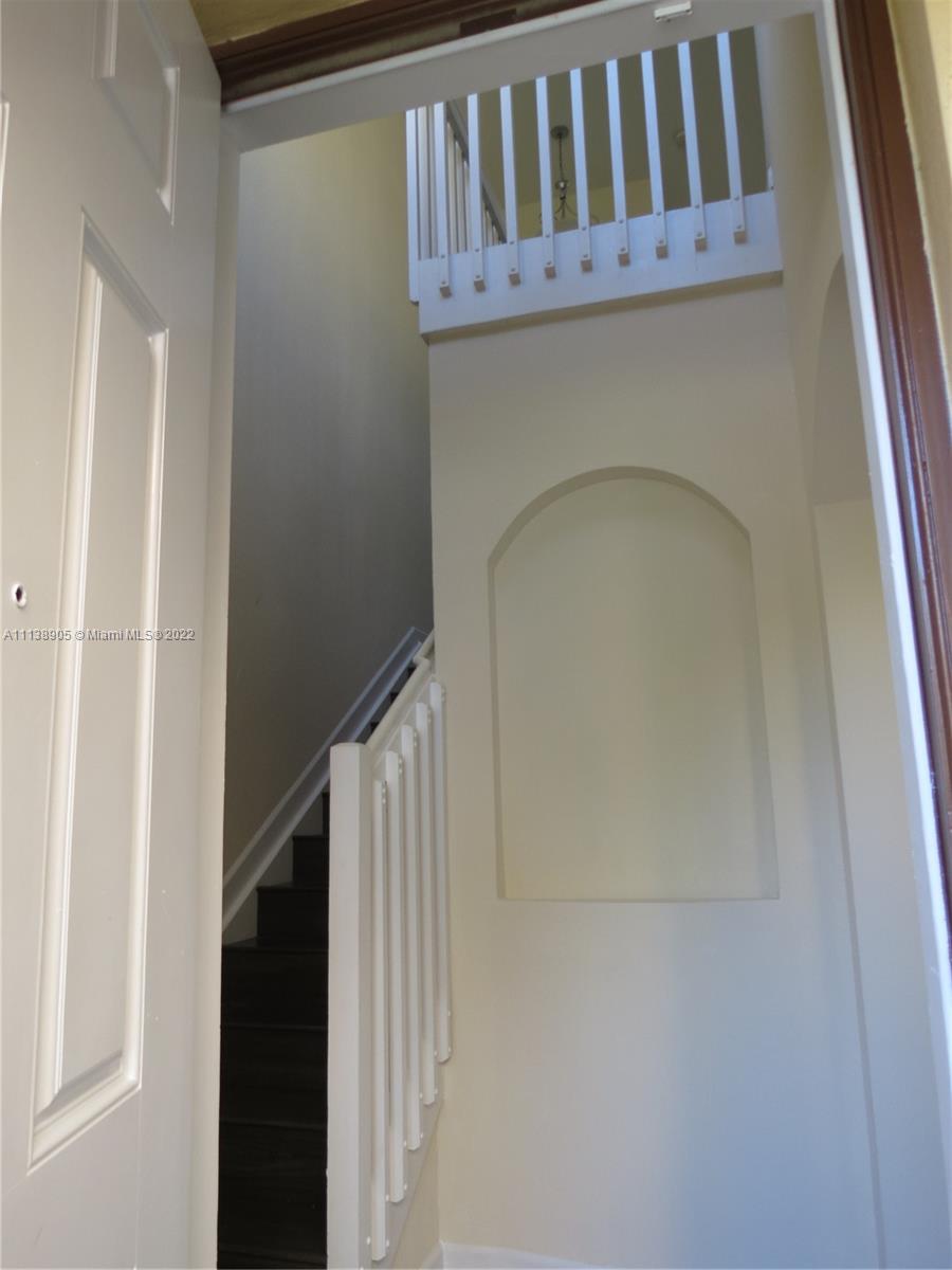 9323 Southwest 227th Street, Unit 75 Cutler Bay, FL 33190 - Photo 4 of 44 a view of staircase with railing and white walls