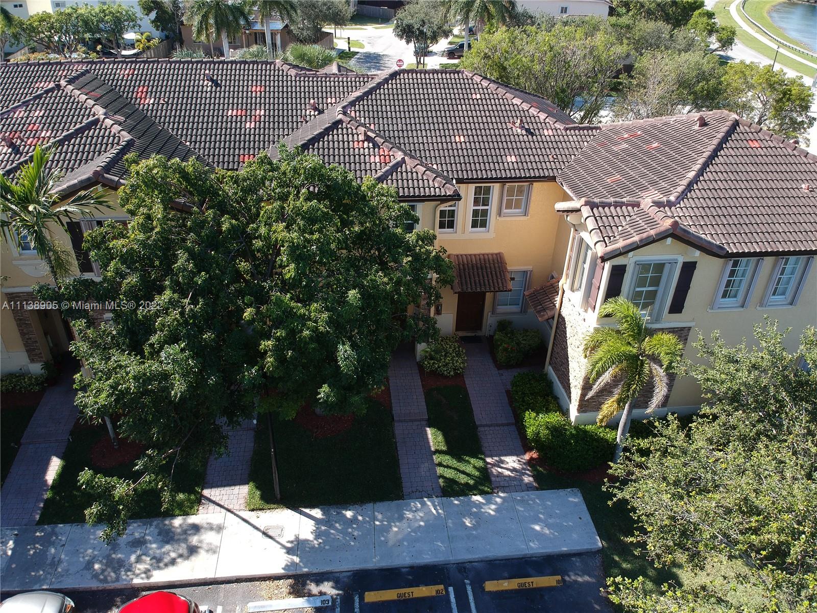 9323 Southwest 227th Street, Unit 75 Cutler Bay, FL 33190 - Photo 41 of 44 a aerial view of a house with a yard and potted plants