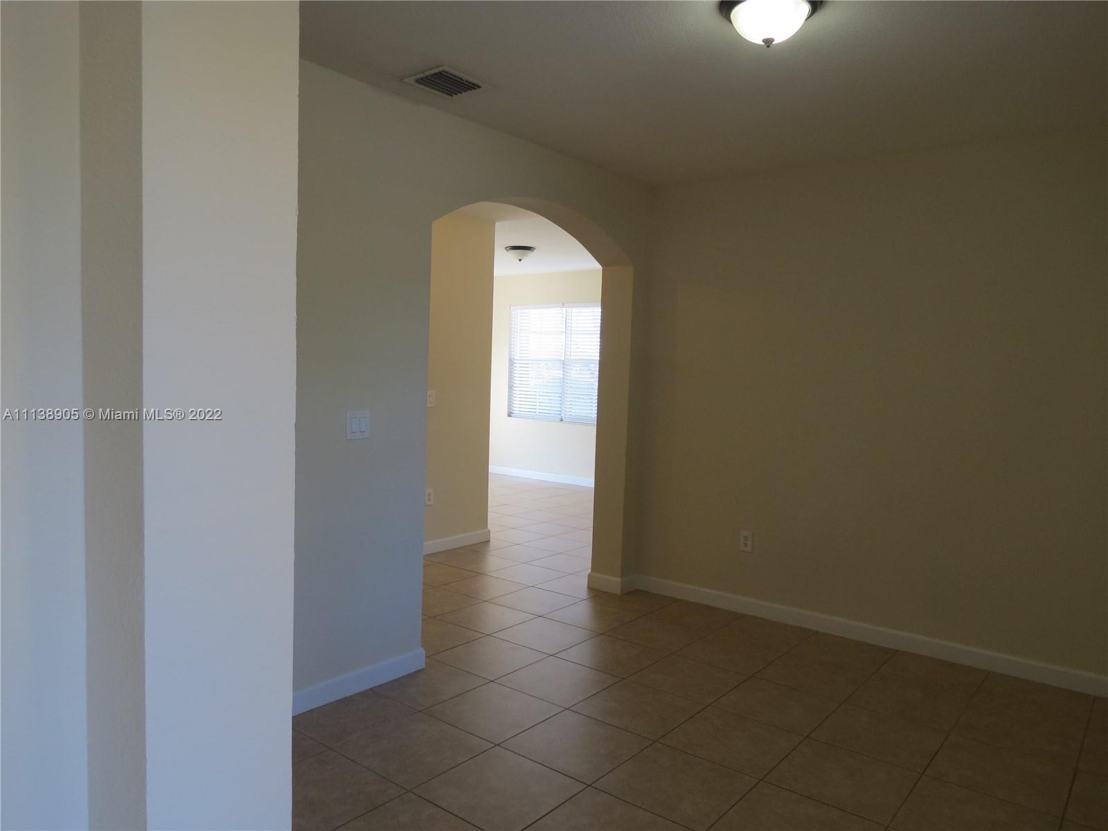 9323 Southwest 227th Street, Unit 75 Cutler Bay, FL 33190 - Photo 5 of 44 an empty room with a window