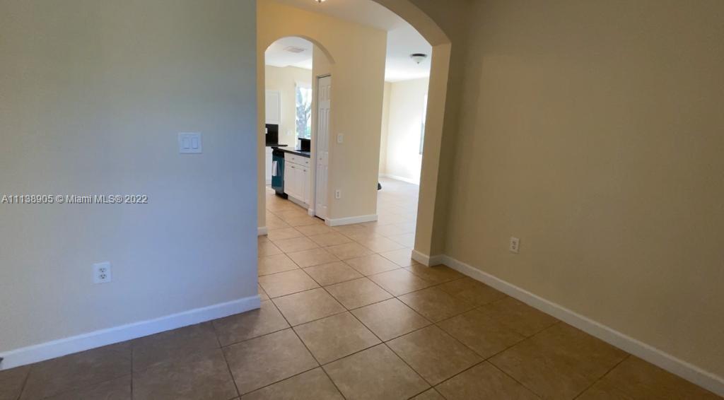 9323 Southwest 227th Street, Unit 75 Cutler Bay, FL 33190 - Photo 6 of 44 an empty room with a bathroom