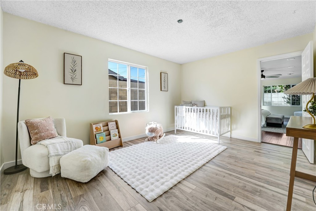 21323 Martin Street Carson, CA 90745 - Photo 14 of 21 a bedroom with furniture and wooden floor