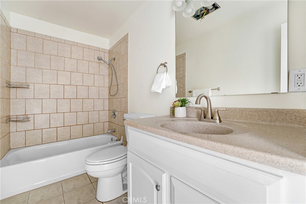 21323 Martin Street Carson, CA 90745 - Photo 15 of 21 a bathroom with a granite countertop bathtub sink vanity mirror and toilet