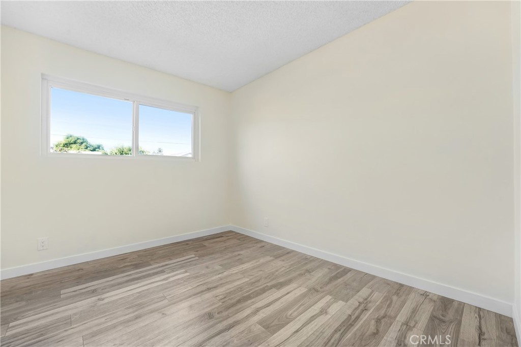 21323 Martin Street Carson, CA 90745 - Photo 18 of 21 a view of a room that has wooden floor and small window