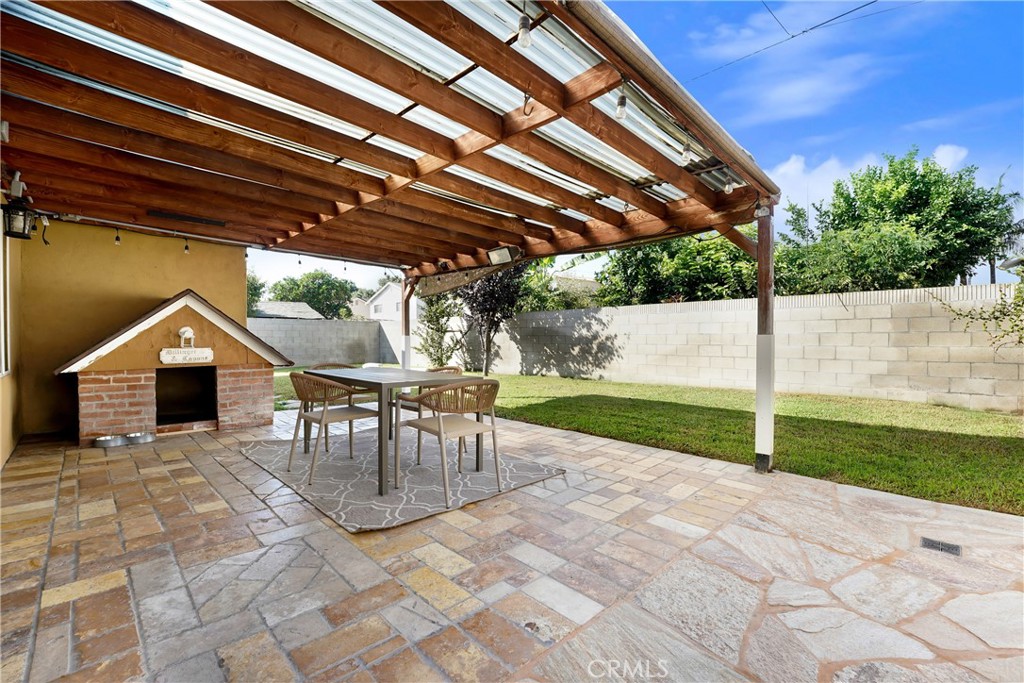 21323 Martin Street Carson, CA 90745 - Photo 20 of 21 a view of a patio with a table and chairs under an umbrella with a tub