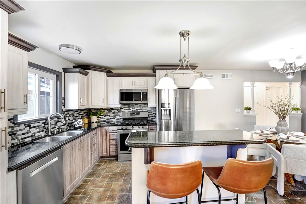 21323 Martin Street Carson, CA 90745 - Photo 5 of 21 a kitchen with stainless steel appliances a sink stove and a refrigerator