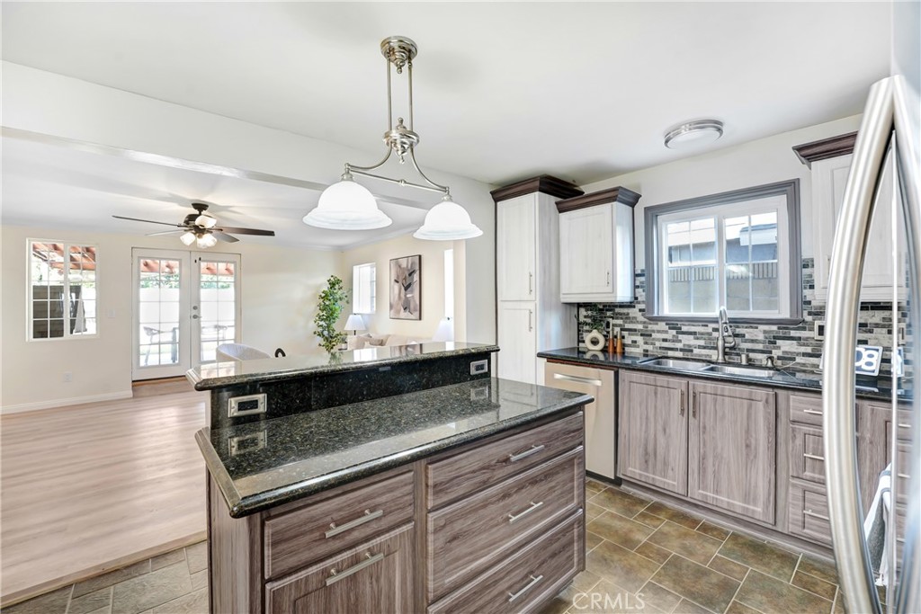 21323 Martin Street Carson, CA 90745 - Photo 6 of 21 a kitchen with stainless steel appliances granite countertop a stove and a wooden floors