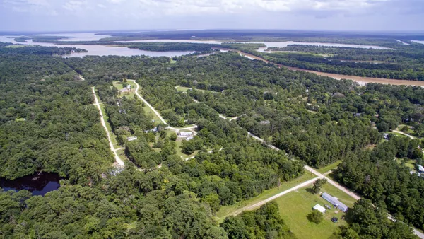 an aerial view of a house with a yard