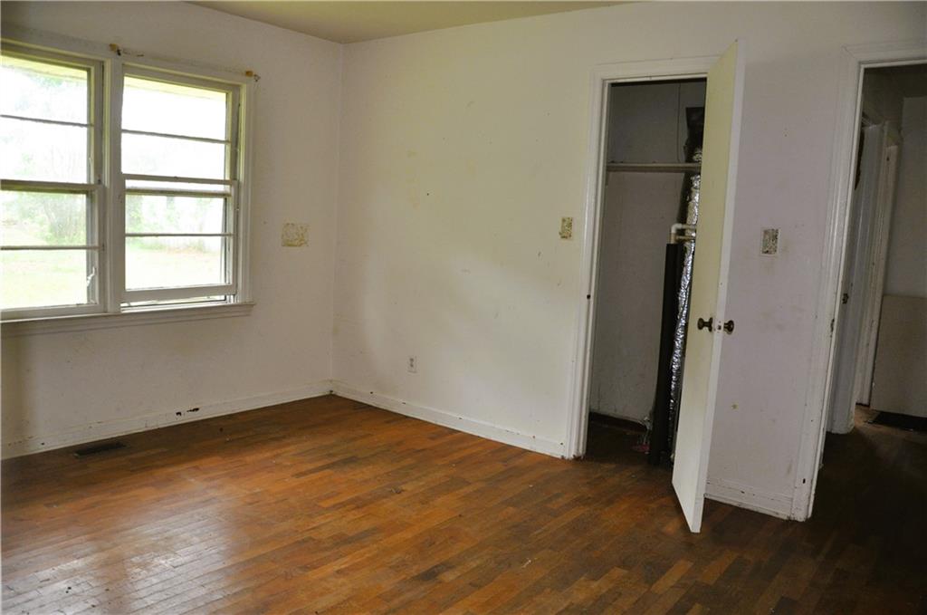 590 Villa Rica Highway Dallas, GA 30157 - Photo 7 of 11 an empty room with wooden floor and windows