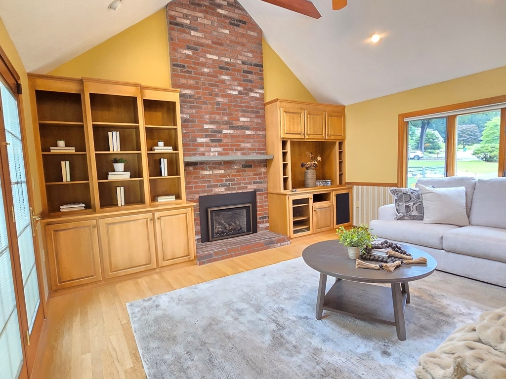42 Wayside Lane Ashland, MA 01721 - Photo 17 of 40 a living room with furniture a fireplace and a flat screen tv