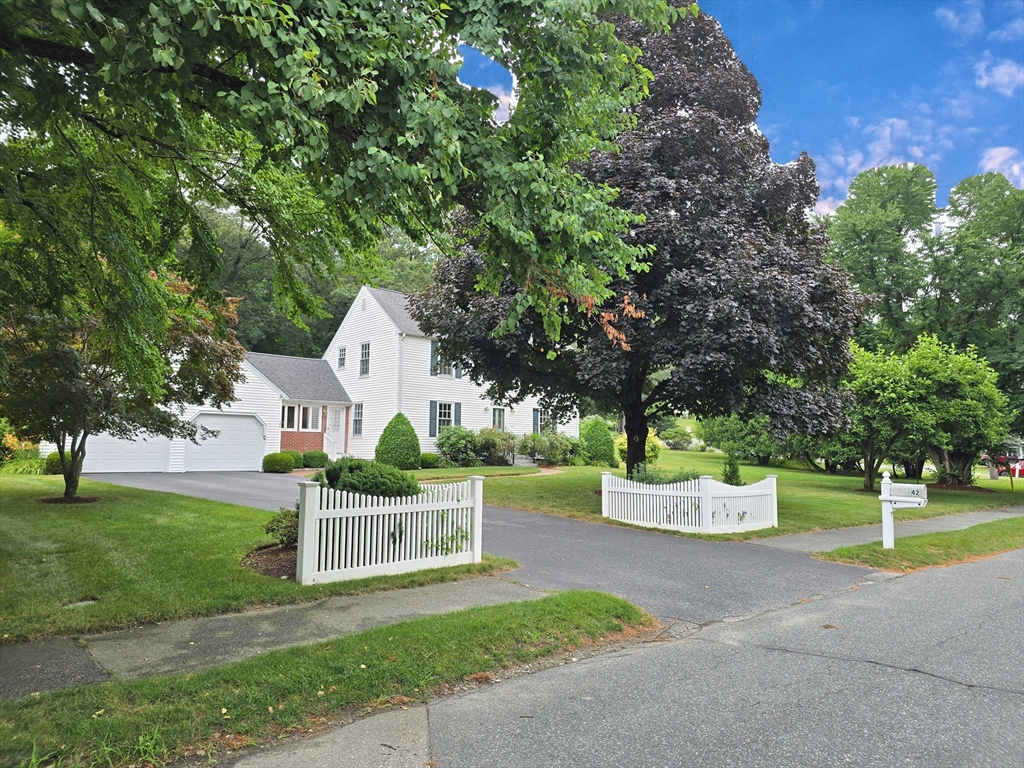 42 Wayside Lane Ashland, MA 01721 - Photo 2 of 40 a view of a house with a yard and large trees