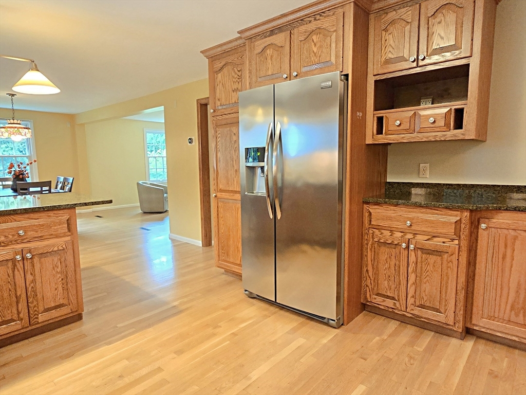 42 Wayside Lane Ashland, MA 01721 - Photo 22 of 40 a kitchen with stainless steel appliances granite countertop a refrigerator a stove and a sink