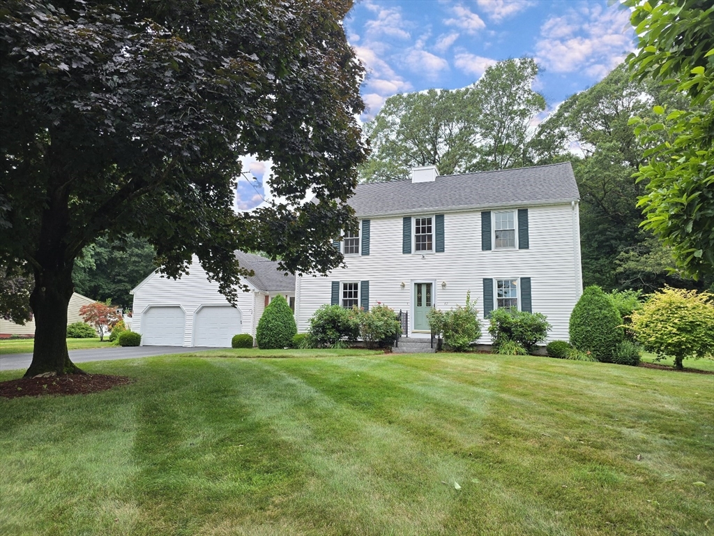 42 Wayside Lane Ashland, MA 01721 - Photo 40 of 40 a front view of a house with a yard and garage