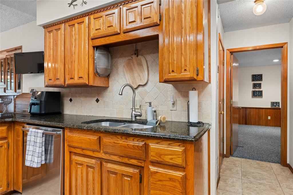 5840 Crystal Drive Midlothian, TX 76065 - Photo 11 of 36 a kitchen with stainless steel appliances granite countertop a sink and cabinets