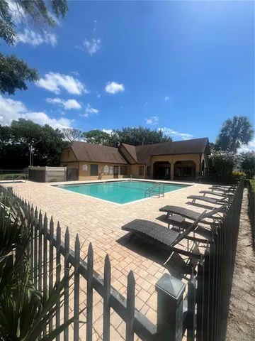 a view of swimming pool with mountain view and seating space