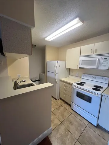 a kitchen with a stove and a refrigerator