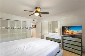 1435 Southeast 15th Street, Unit 103 Fort Lauderdale, FL 33316 - Photo 23 of 33 a bedroom with a bed and a chandelier