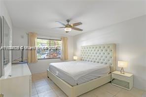 1435 Southeast 15th Street, Unit 103 Fort Lauderdale, FL 33316 - Photo 27 of 33 a bedroom with a bed and a large window